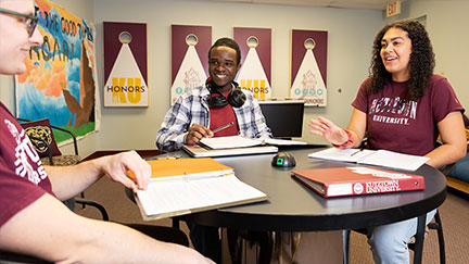 Communication Studies students at Kutztown University sitting at a table.