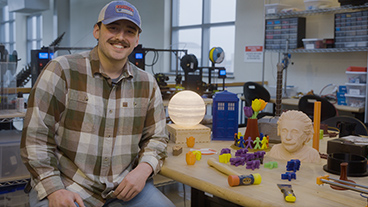 Male student from Physics: Engineering Technology degree in on-campus 3D printing lab.
