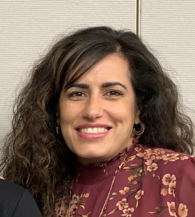 woman smiling wearing maroon shirt