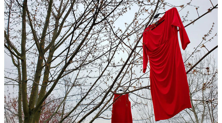 Red dresses hanging in trees