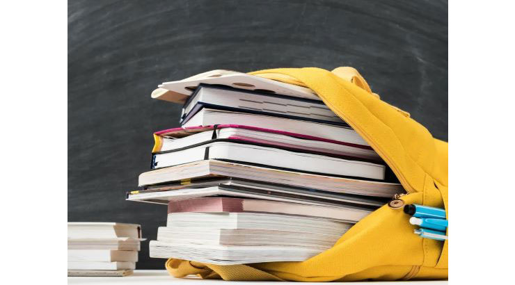 Textbooks in a yellow backpack.