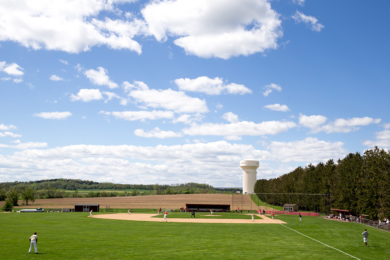 Distant shot of baseball players practicing on the diamond at north campus field with the KU water tower in the background 