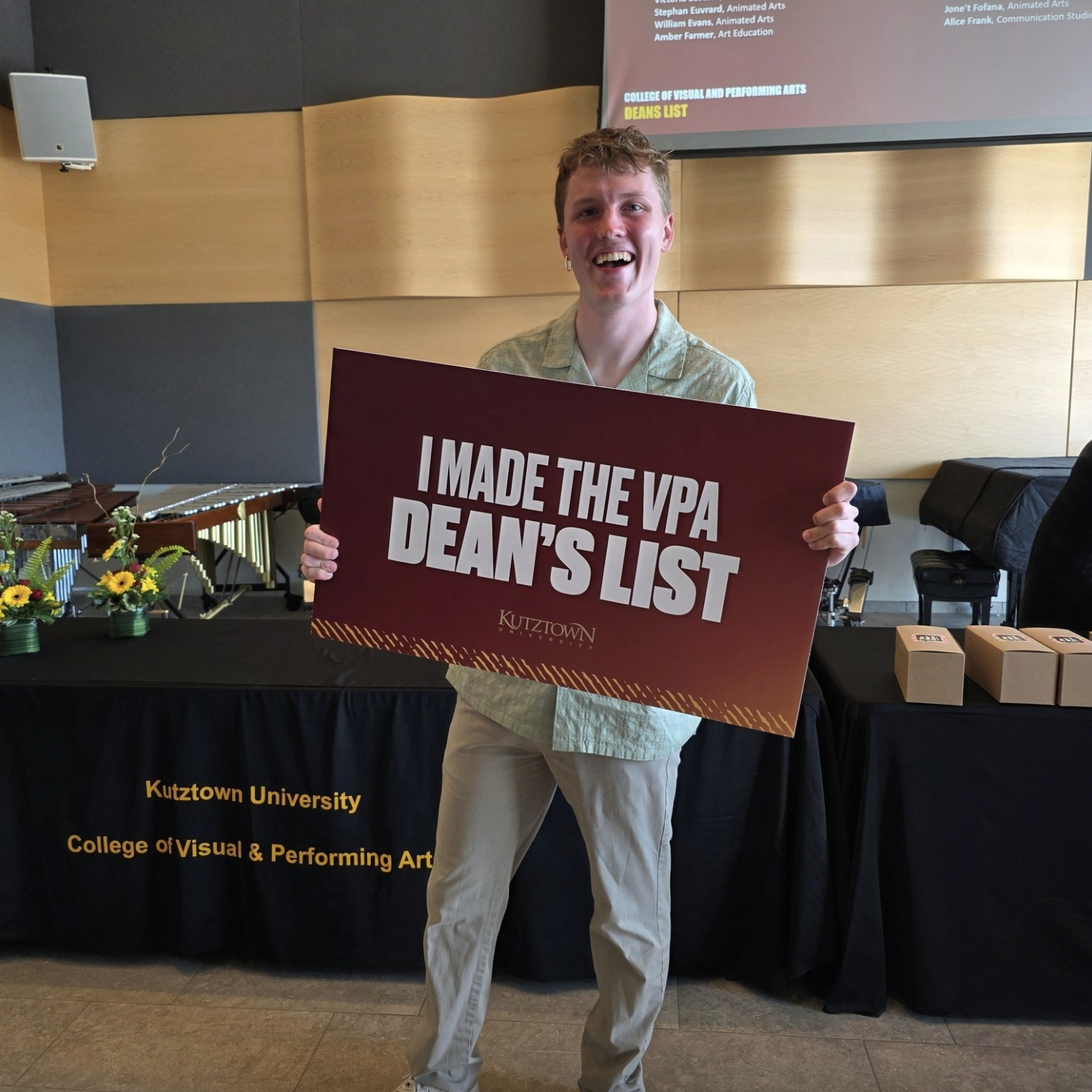 Student holds up sign reading: I made the VPA Dean's List