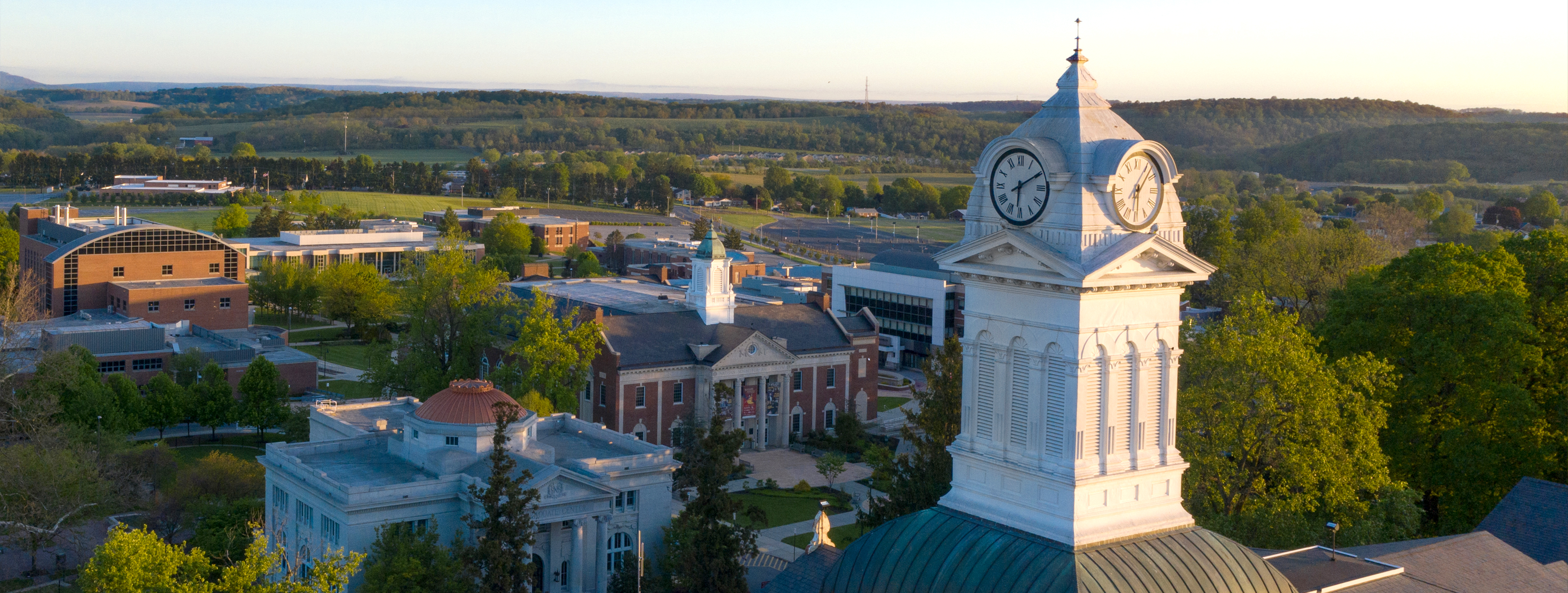 Drone picture of Old Main clocktower with classrooms in the background