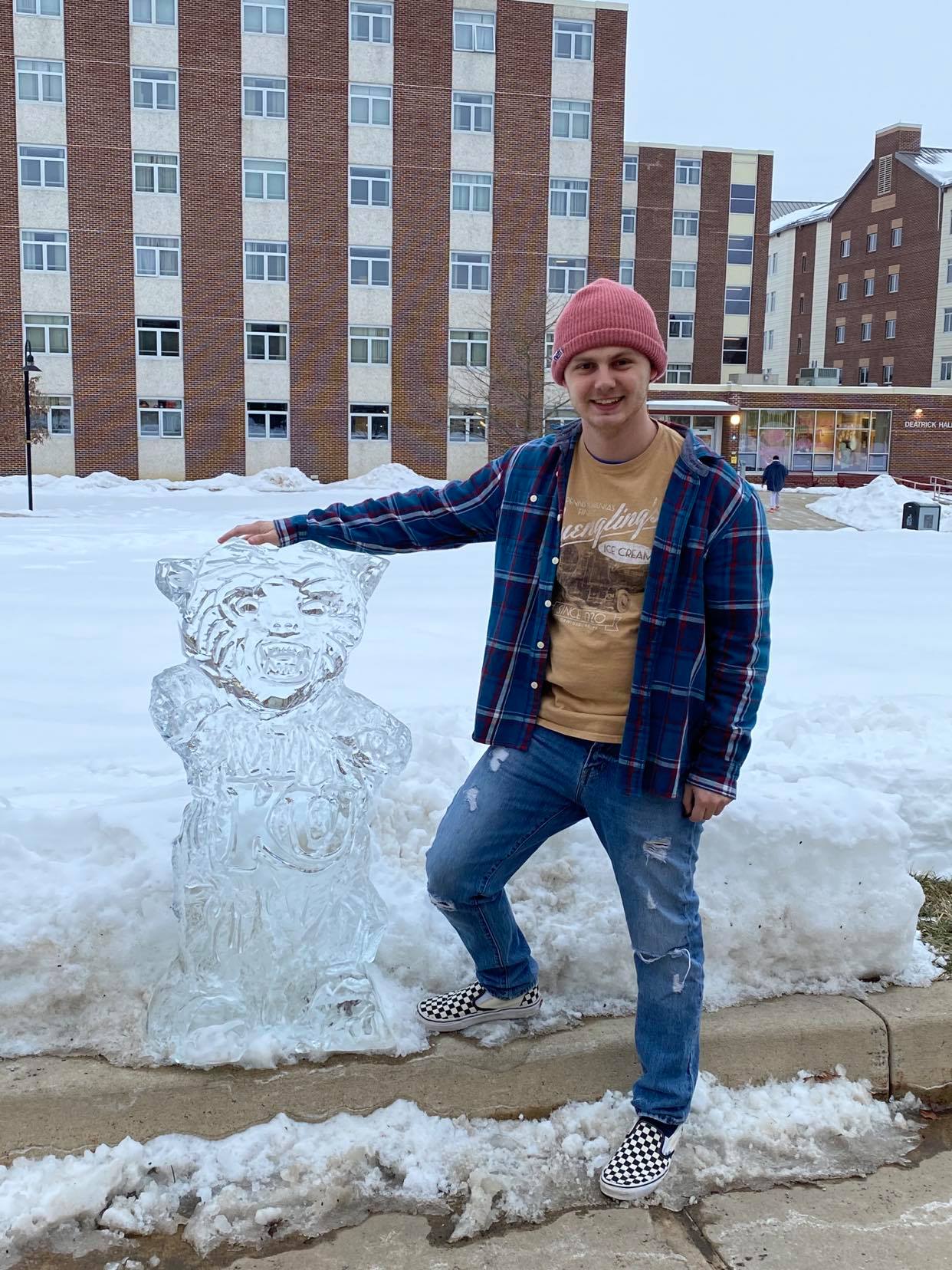 Zach Goodman next to a bear ice sculpture