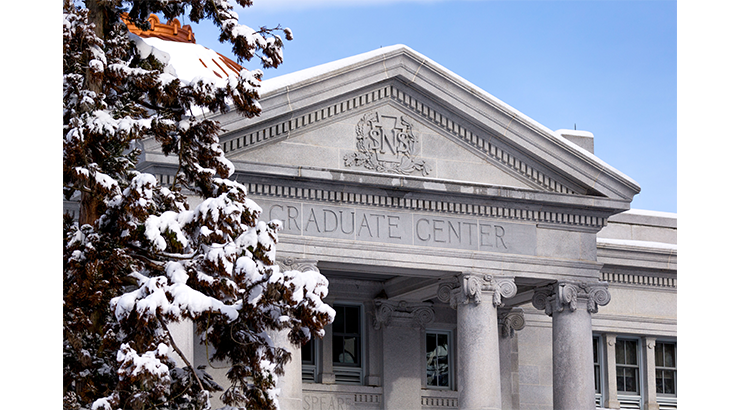 Graduate Center building with trees covered in snow to the left.