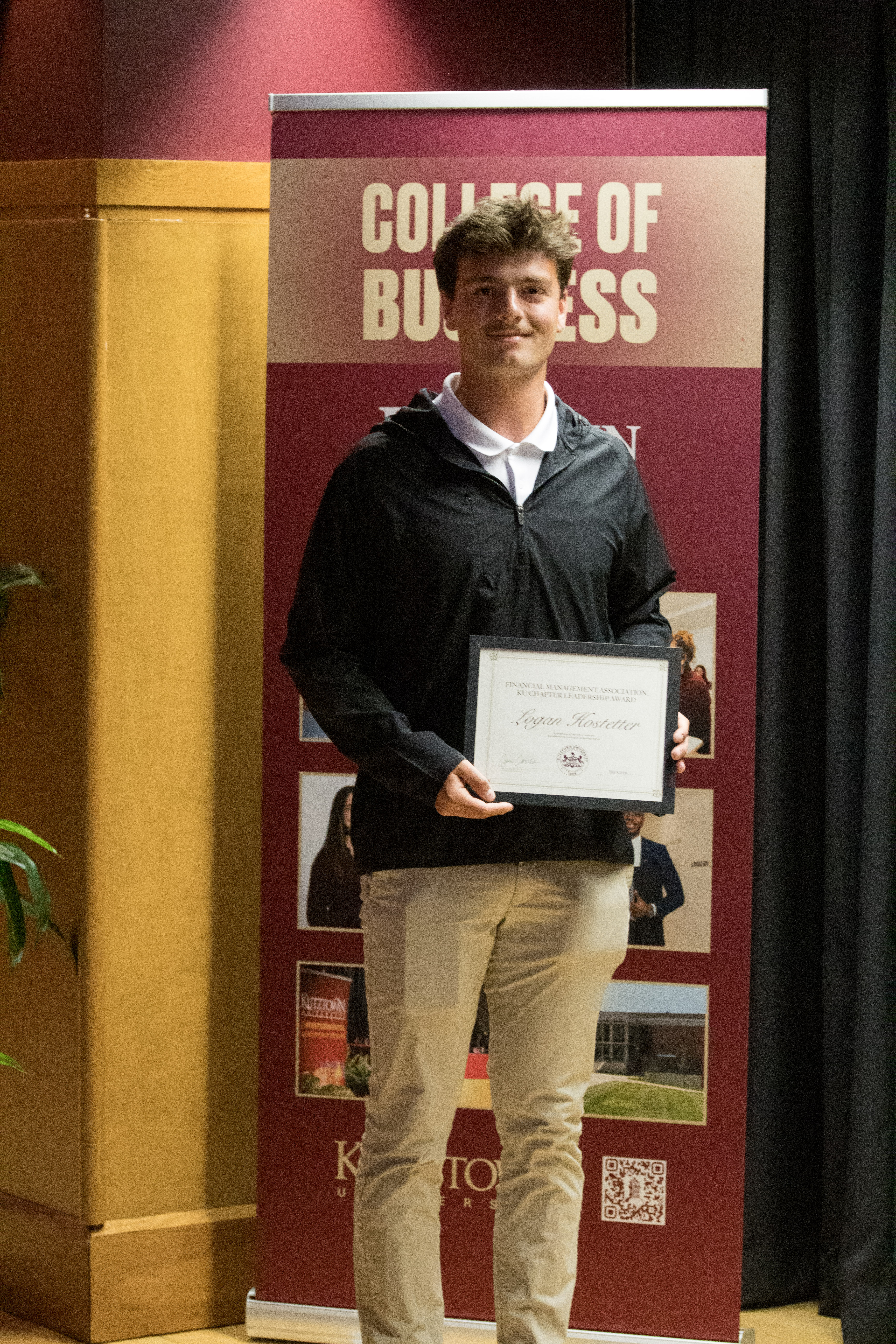 Logan Hostetter with award certificate