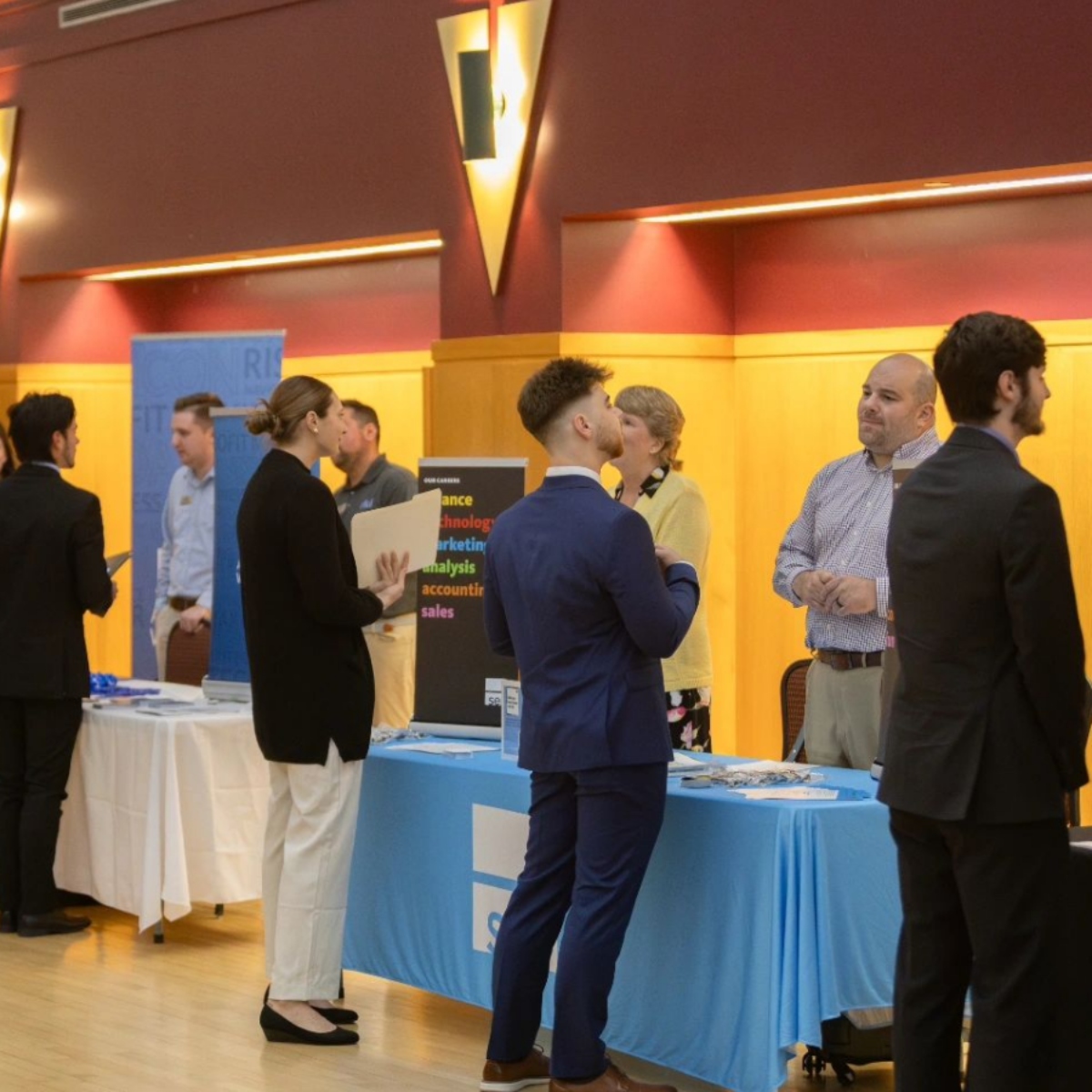 Students, Faculty members and industry professionals networking in the de Francesco lobby