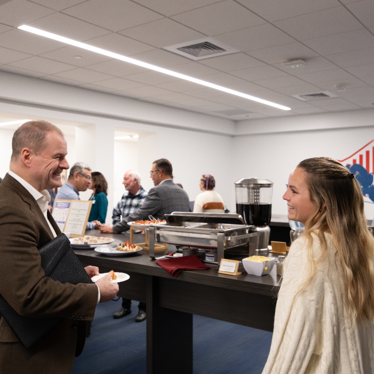two people standing in the de Francesco lobby networking