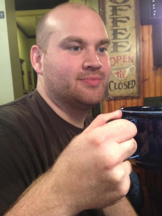 Scott Bastedo headshot, with him holding a coffee mug 
