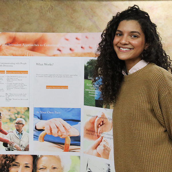 Student in front of a poster presentation