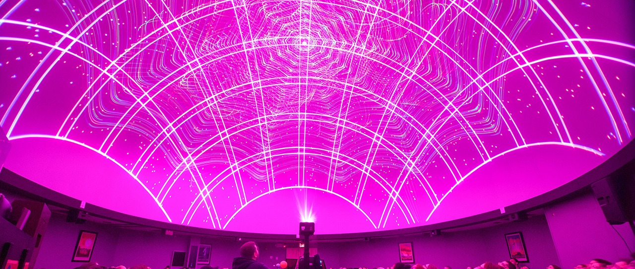 Pink lights projected onto the planetarium ceiling 