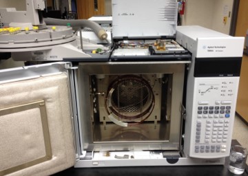 inside compartment of a gas chromatograph with the coil of the colum in the center