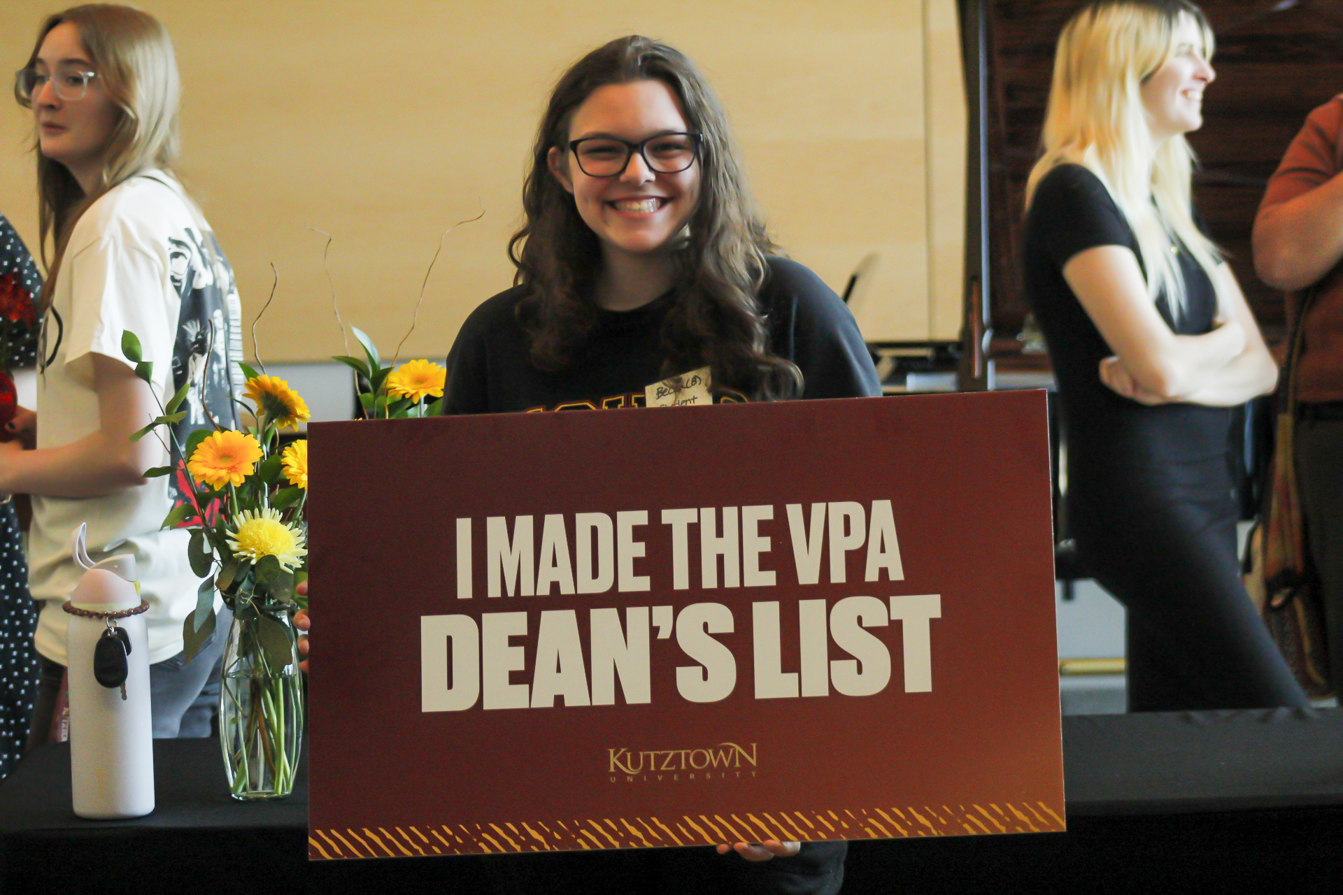 Photo of student holding up a sign reading: I made the VPA Dean's List