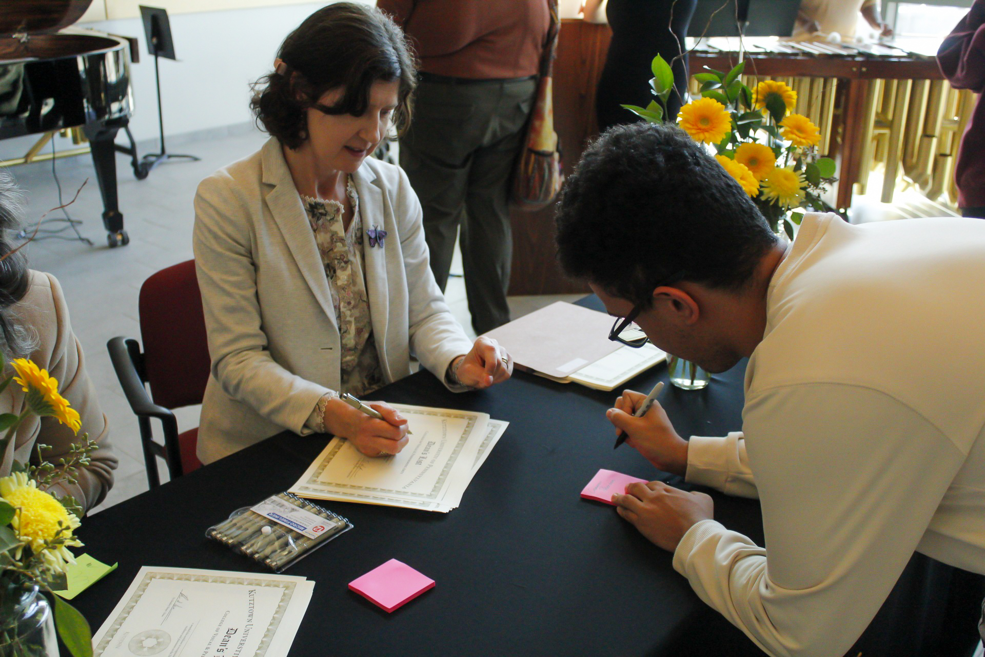 Photo of person signing Dean's List Certificate