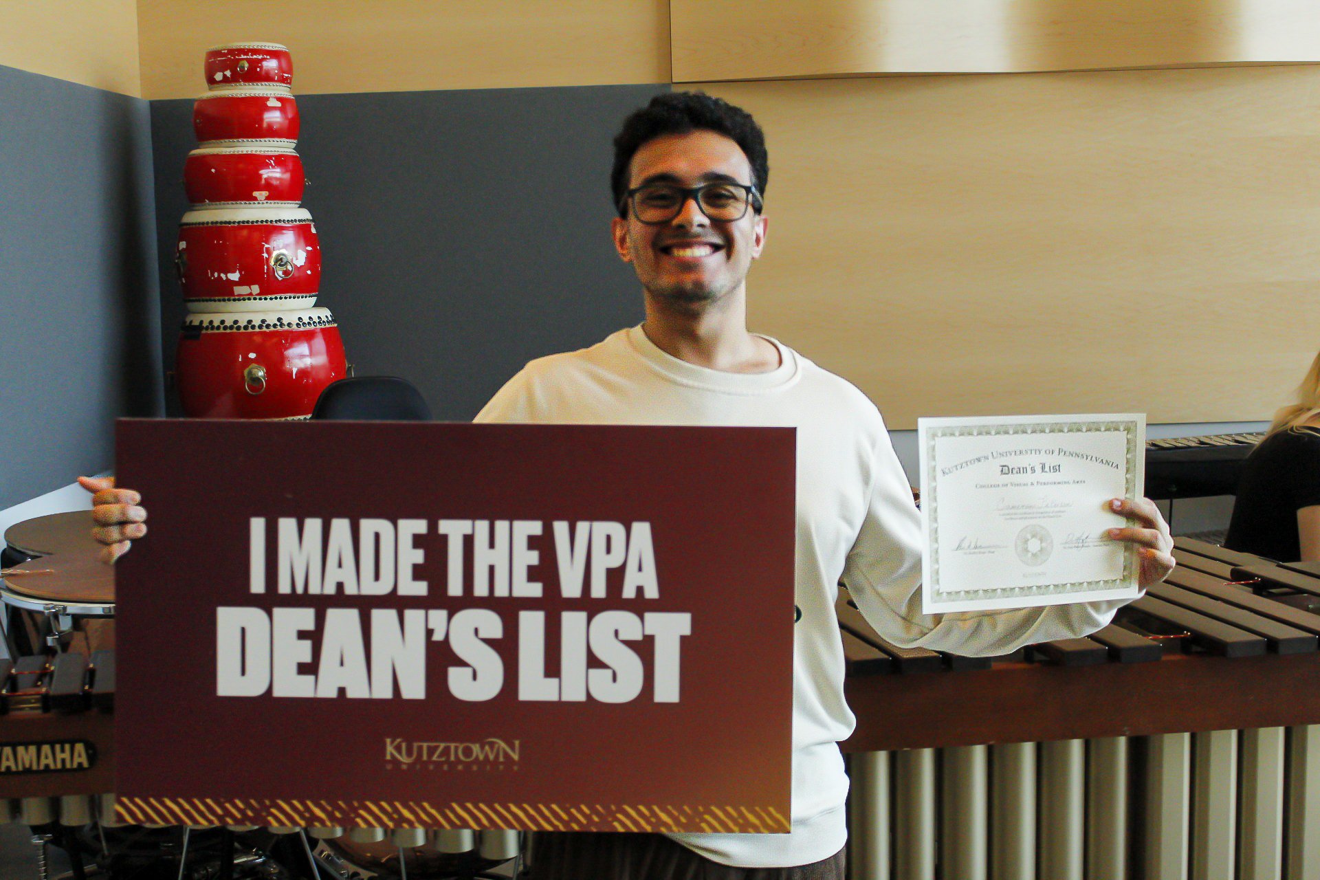 Student holds up sign reading: I made the VPA Dean's List