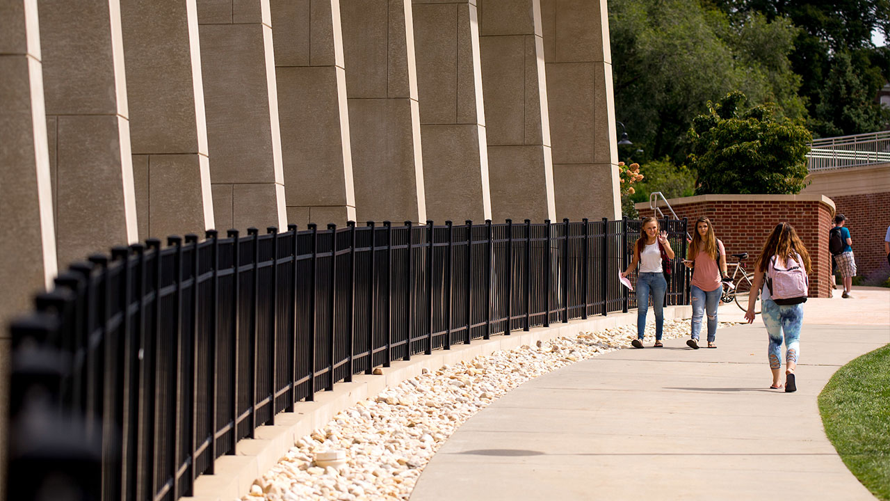 Students walking in front of Sharadin Arts Building concourse. 
