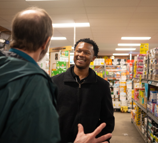Individual smiling while conversing with someone