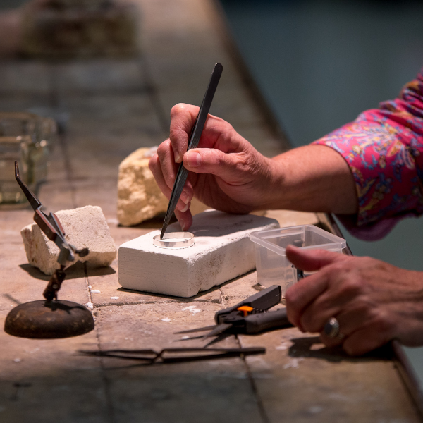 Hands making jewelry