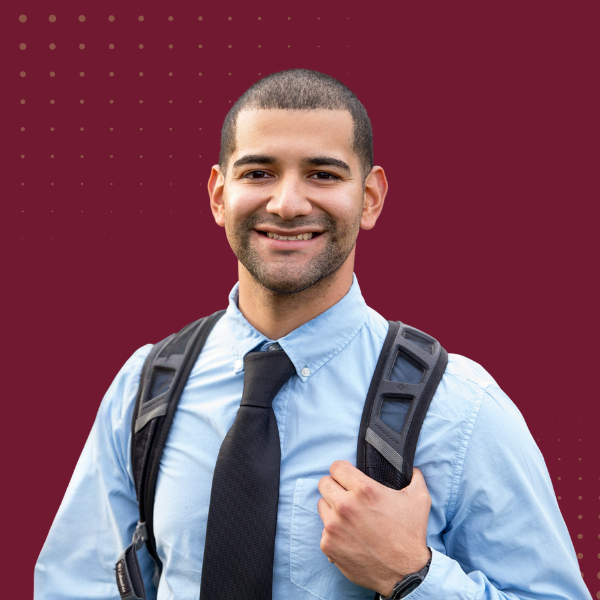 Man wearing backpack smiling at camera
