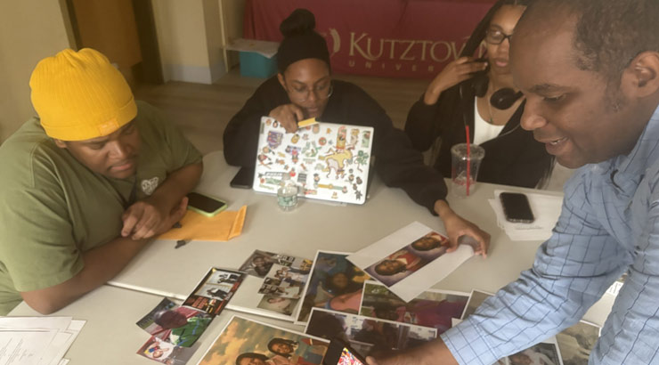 group of professor and students work on paper quilt project.