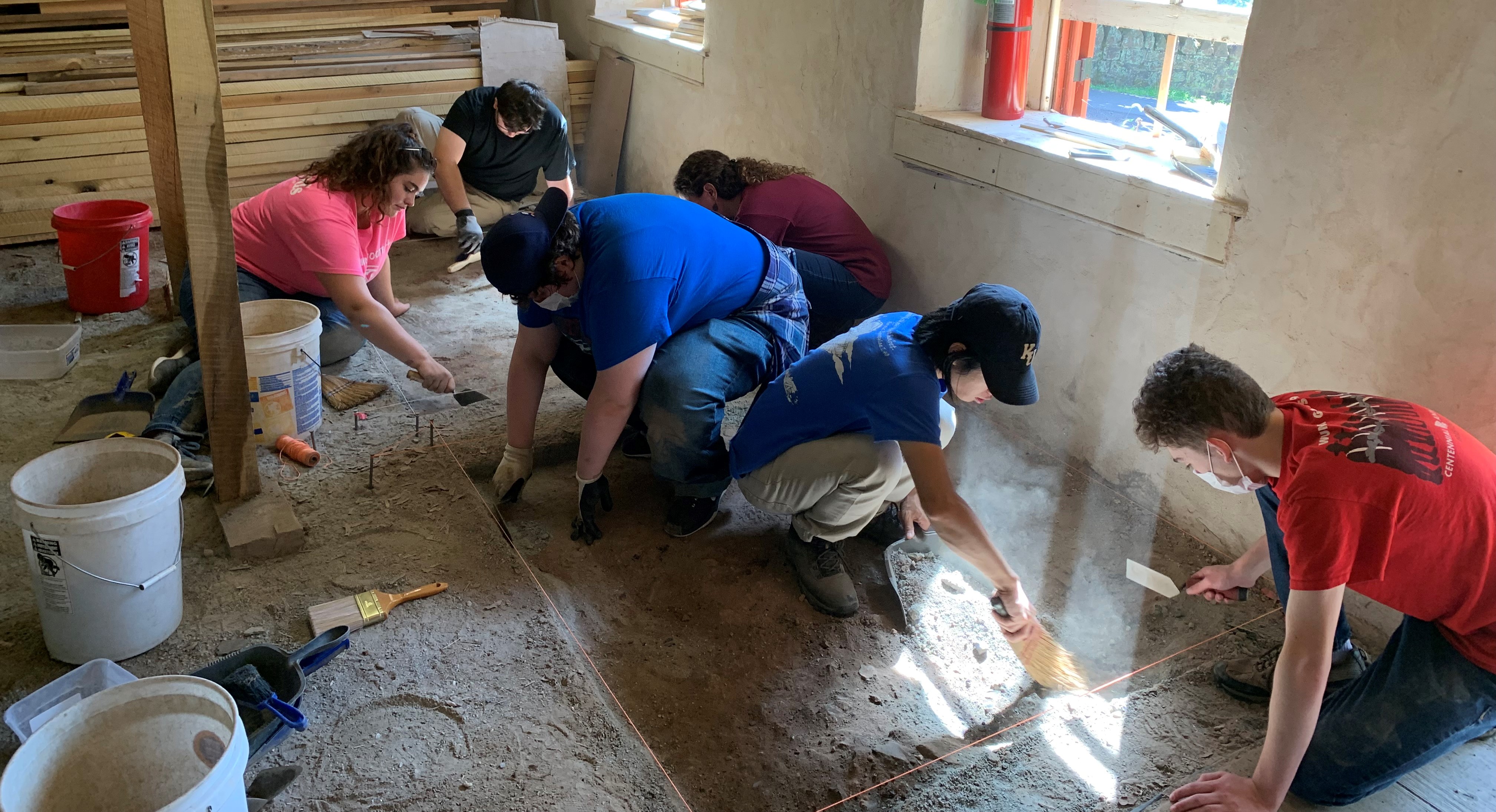 students digging in dirt looking for artifacts