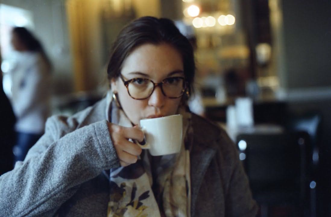 Emily Welsh drinking a cup of coffee
