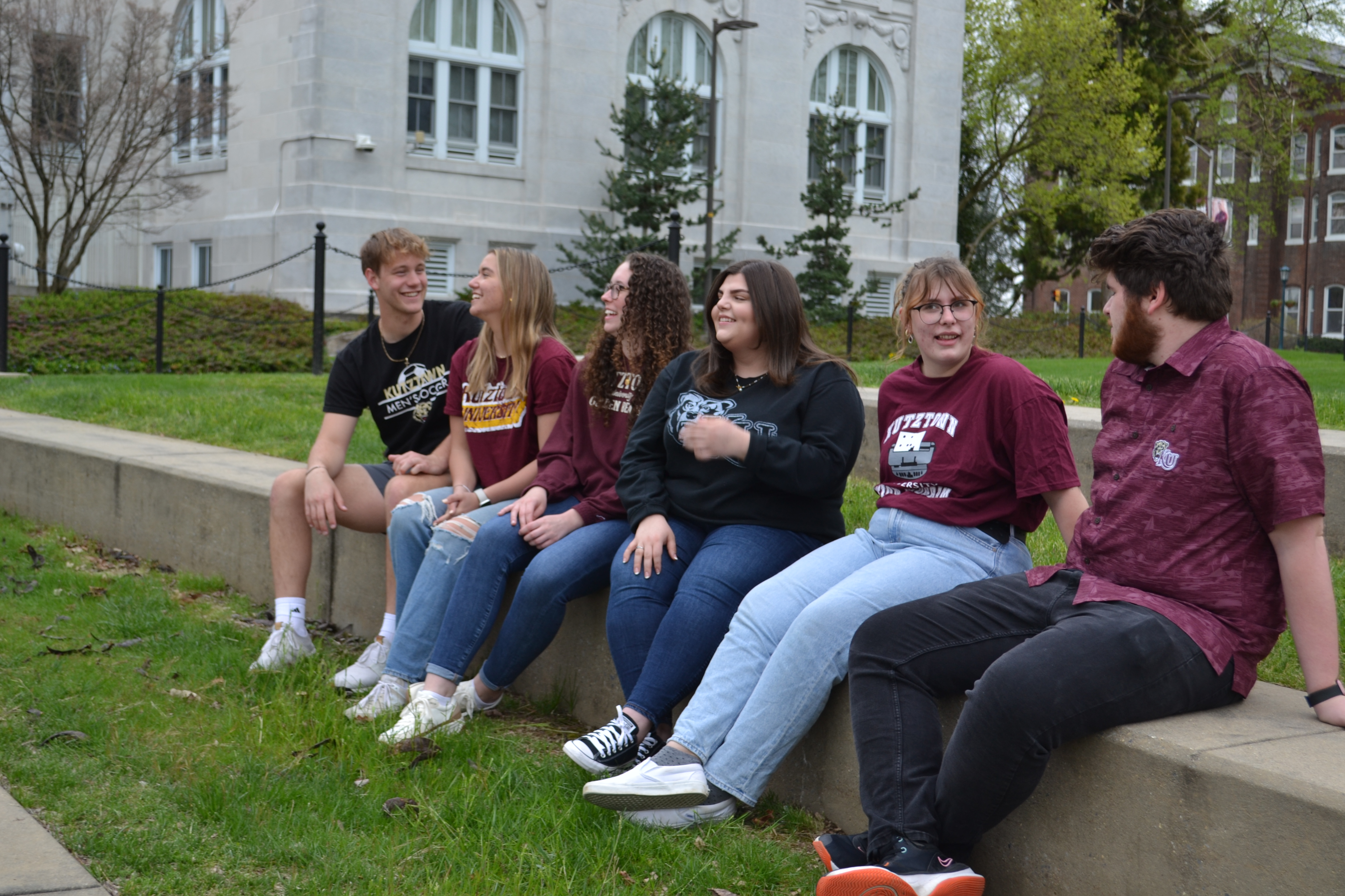 three transfer students smiling in front of the Main fountain 