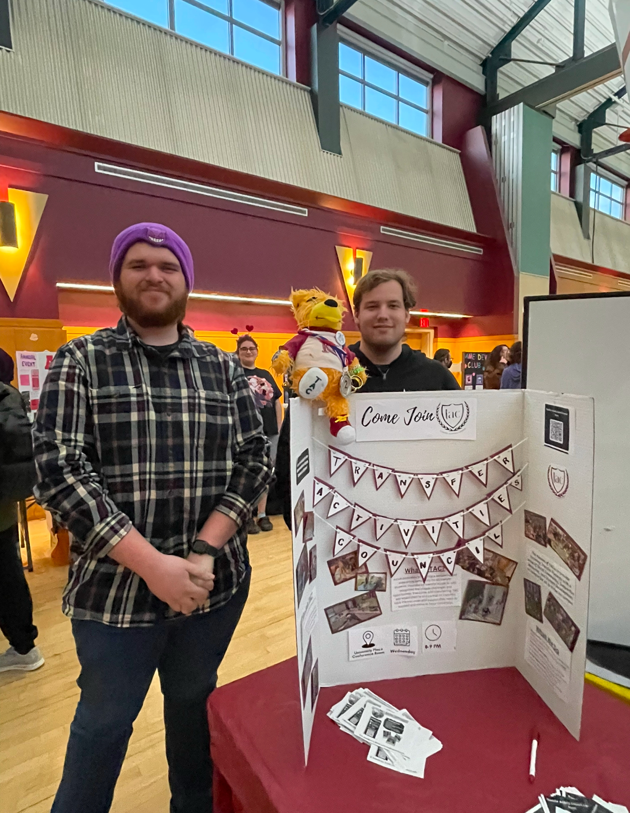 Two T-A-C members tabling with a T-A-C trifold in the MSU multipurpose room