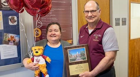Letita Manwiller being presented with the Employee of the Month award and gifts by President Hawkinson 