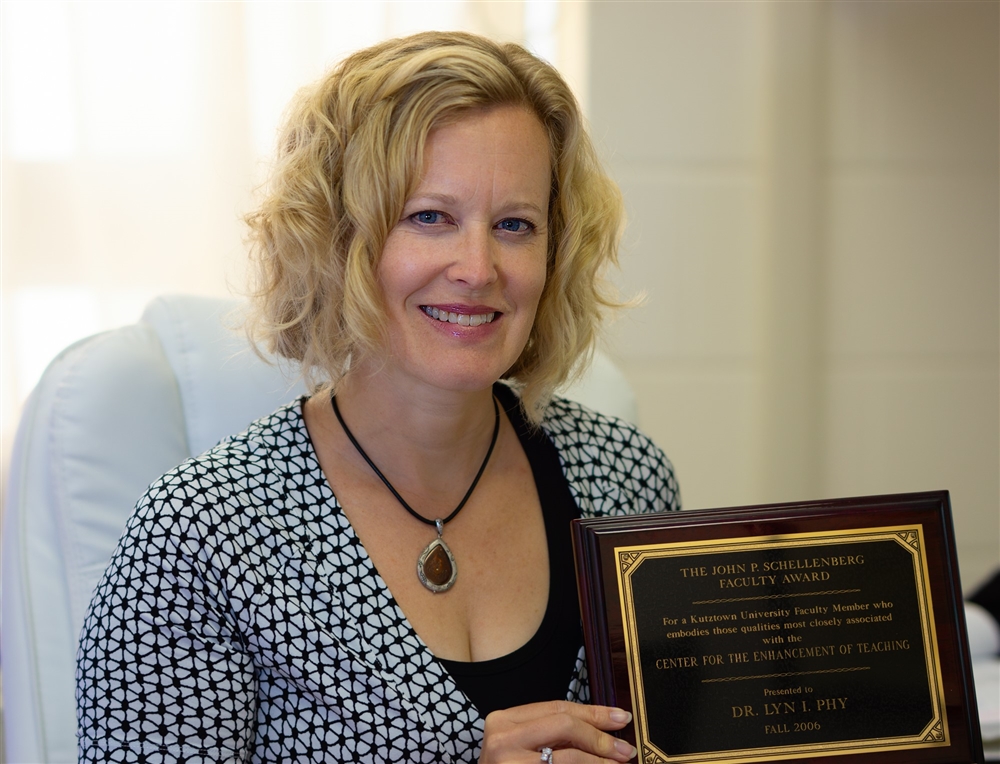 Dr. McQuaid posing with her award