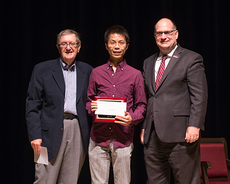Dr. Wong being awarded with Excellence in Teaching award by Dr. Hawkinson 