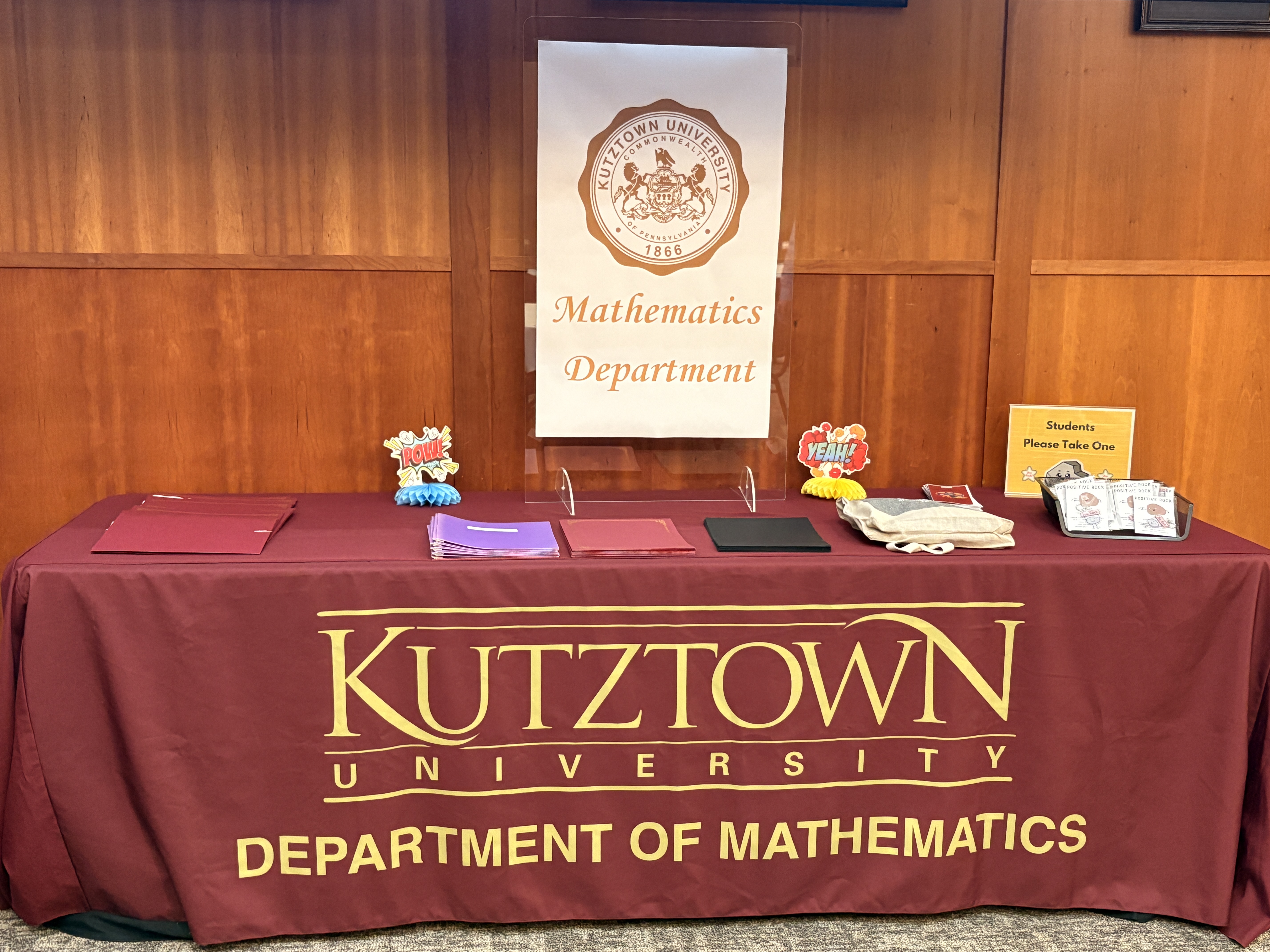 Table with awards maroon and gold "Kutztown University Department of Mathematics" table cloth