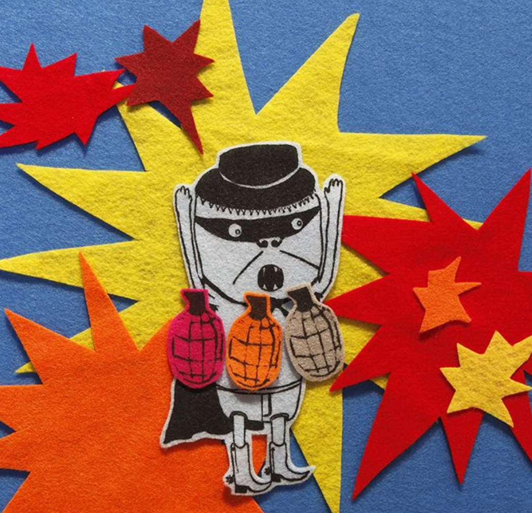 Felt cutouts of a cartoon bandit wearing a belt of grenades, in front of more felt star-shaped explosions 