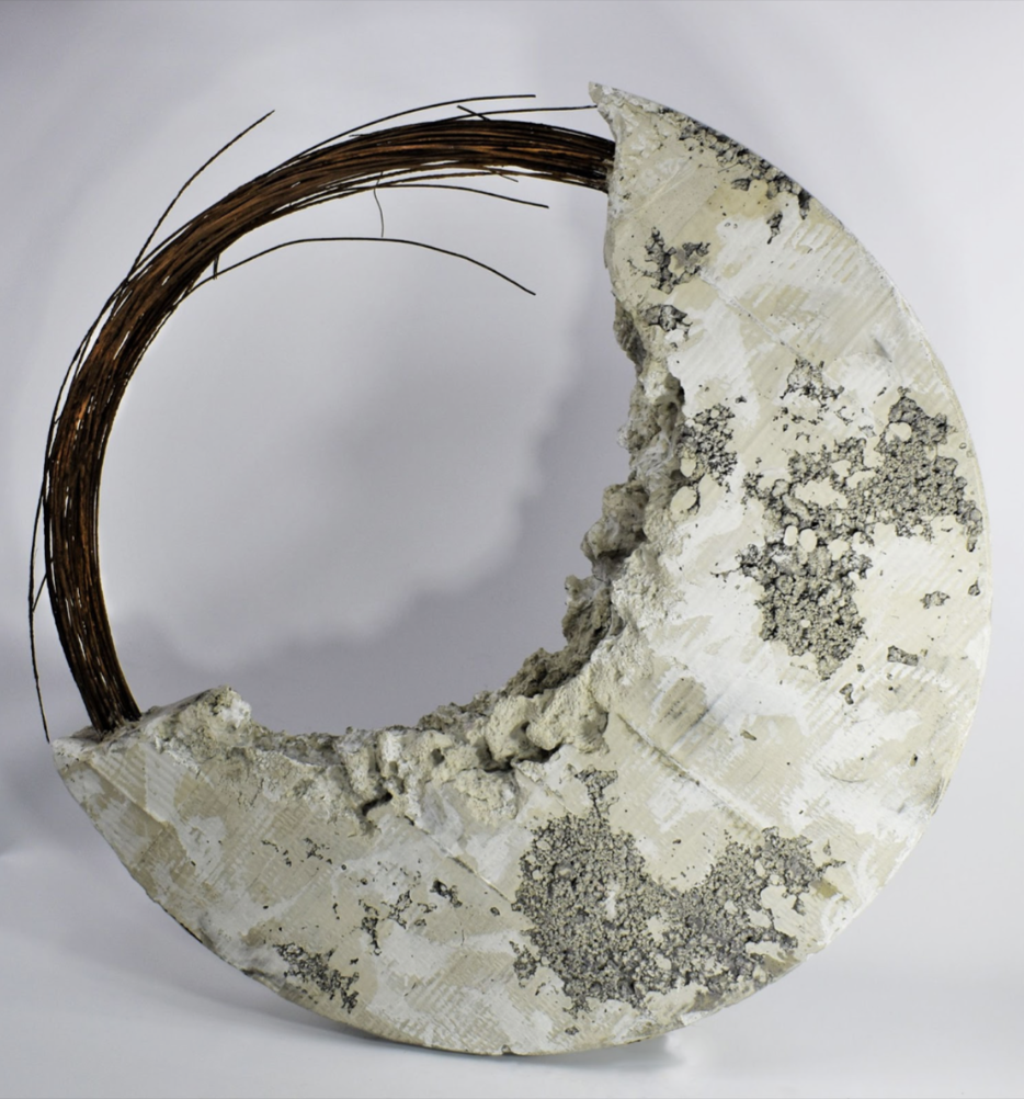 Circular piece made of marbled stone (bottom right) and wood branches (upper left)