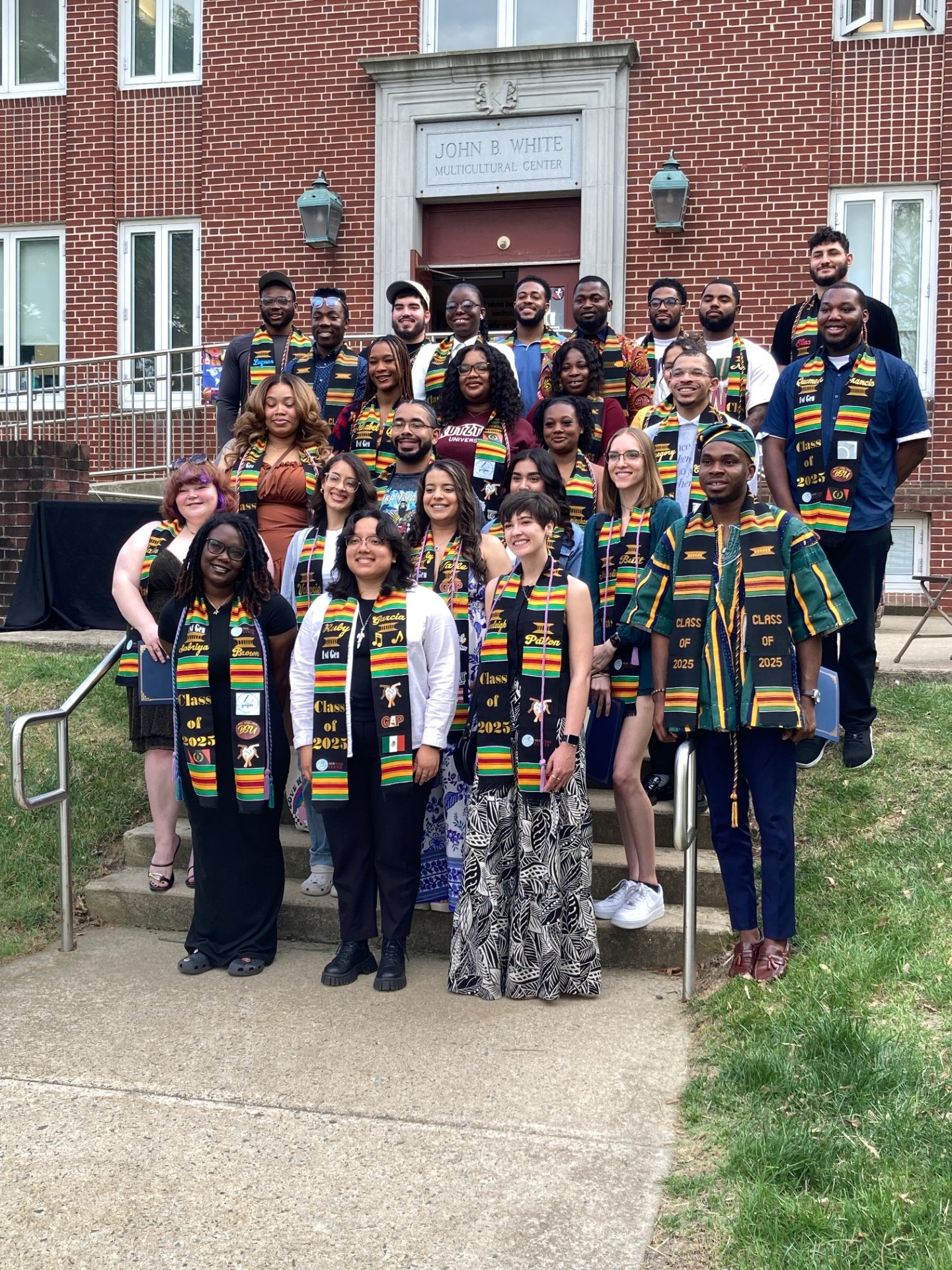 40 Kente Stole Graduates posing in front of Multicultural Center.