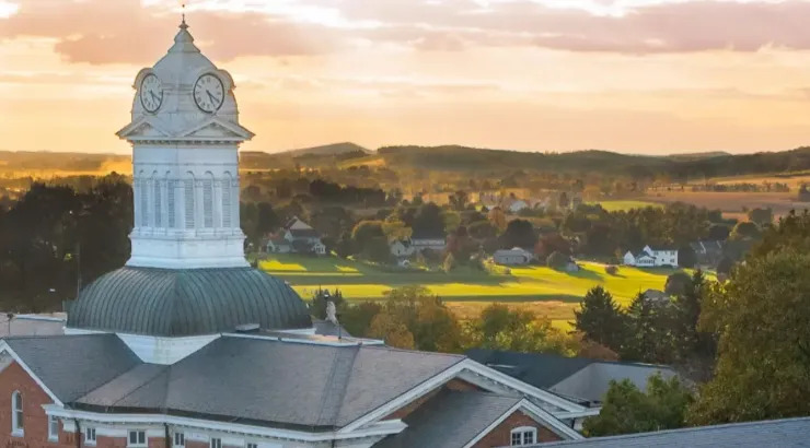 Landscape view of Old Main building with a sunset in the background
