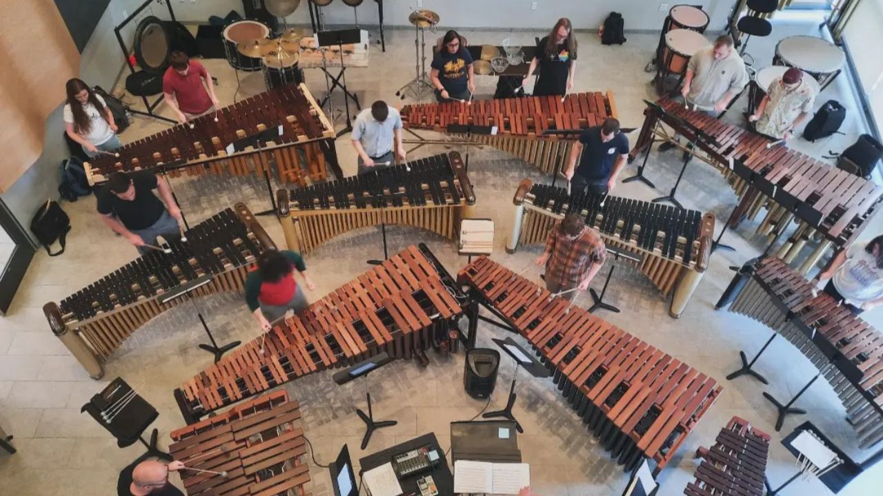 An aerial view of multiple mallet percussion instruments and performers
