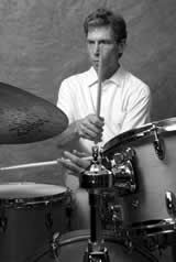black and white picture of john riley playing the drums 