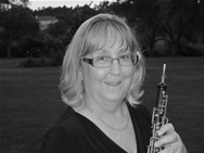 black and white headshot of Kim Webster holding a flute 