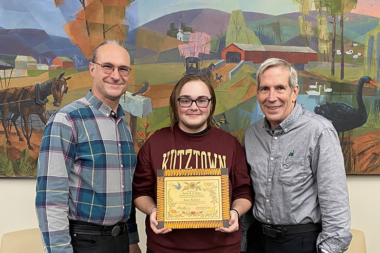 KU Student receives scholarship certificate