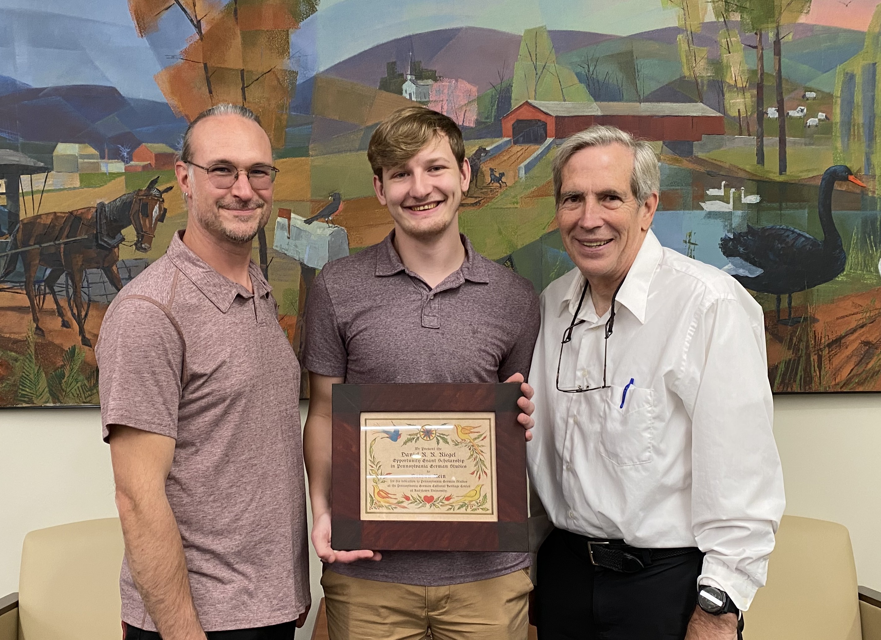 KU Student receiving scholarship certificate