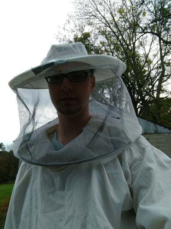 Beekeeper dressed in full protective gear 