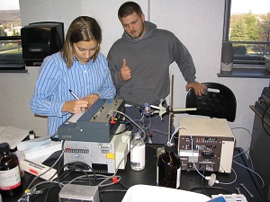 Two students conducting an experiment with electronics in the lab.