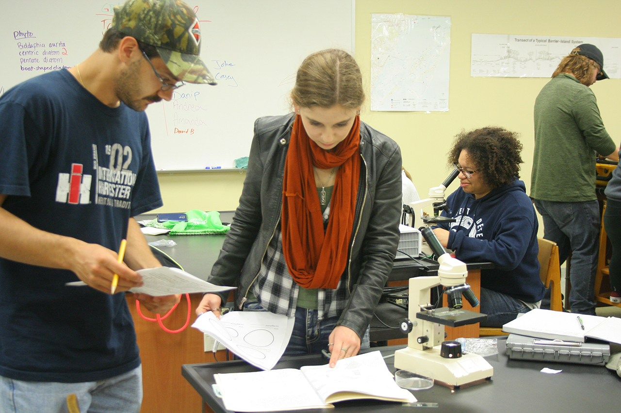 Students with microscopes in the lab