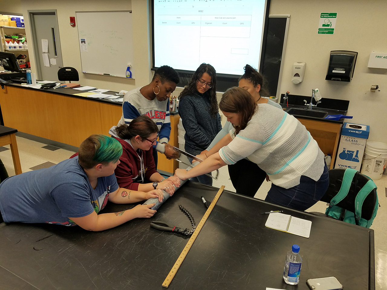 Students cutting cores in the lab