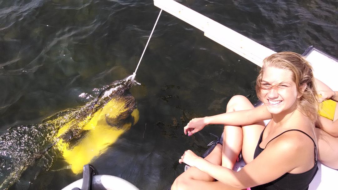 Kelly on the boat with the yellow CHIRP sonar system in the water. 