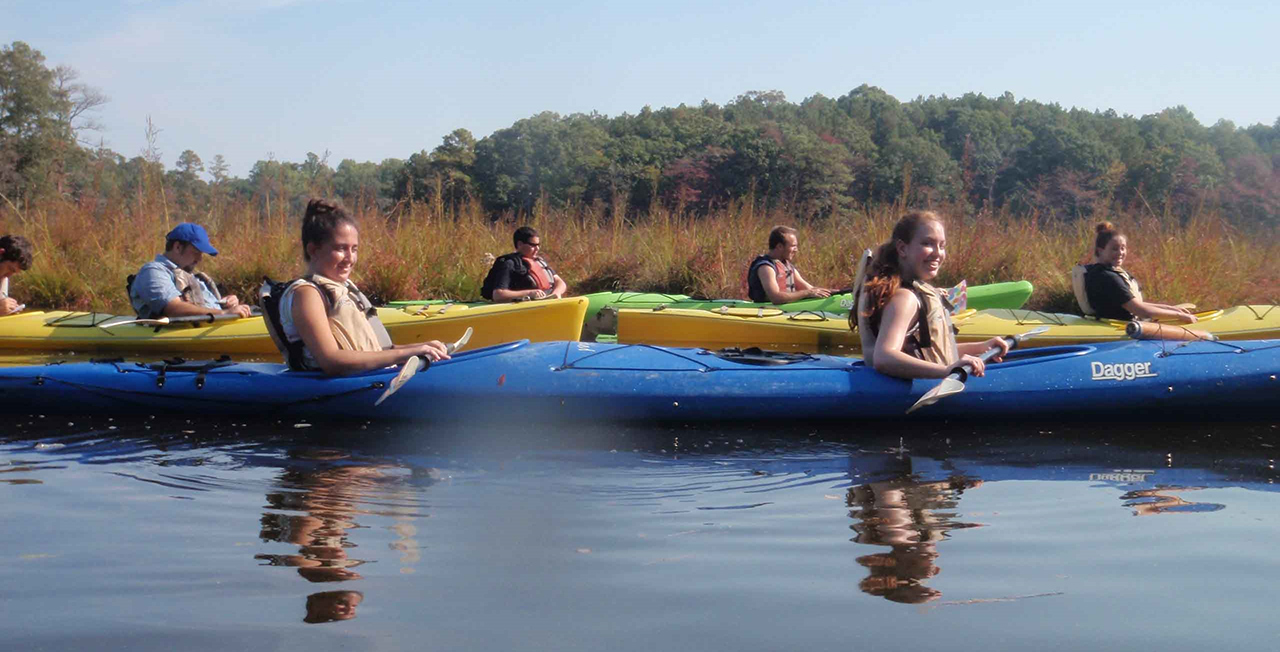 students on kayaks taking measurments 