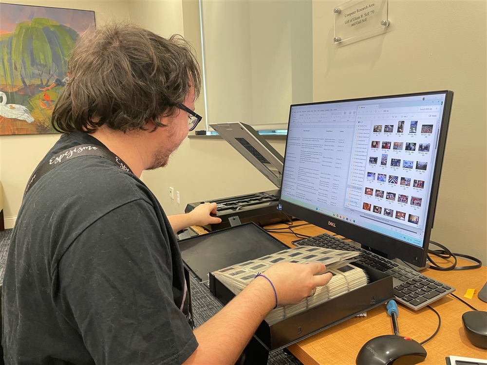 Beau deForest digitizing and cataloguing slides on the computer at the Pennsylvania German Cultural Heritage Center as part of the 2025 KU BEARS program.