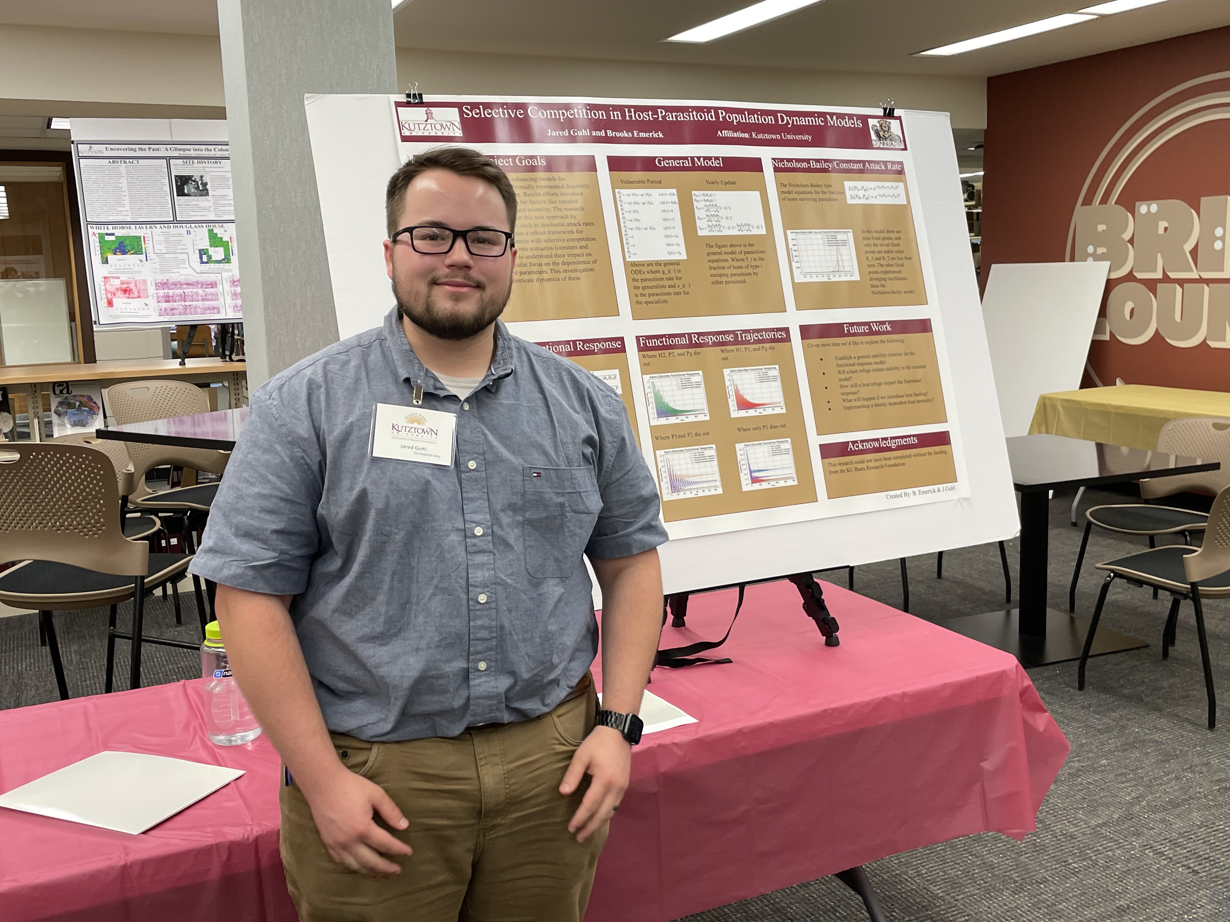 student standing in front of poster at 2024 KU Inspires event